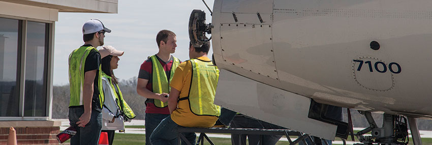 Image of workers and plane